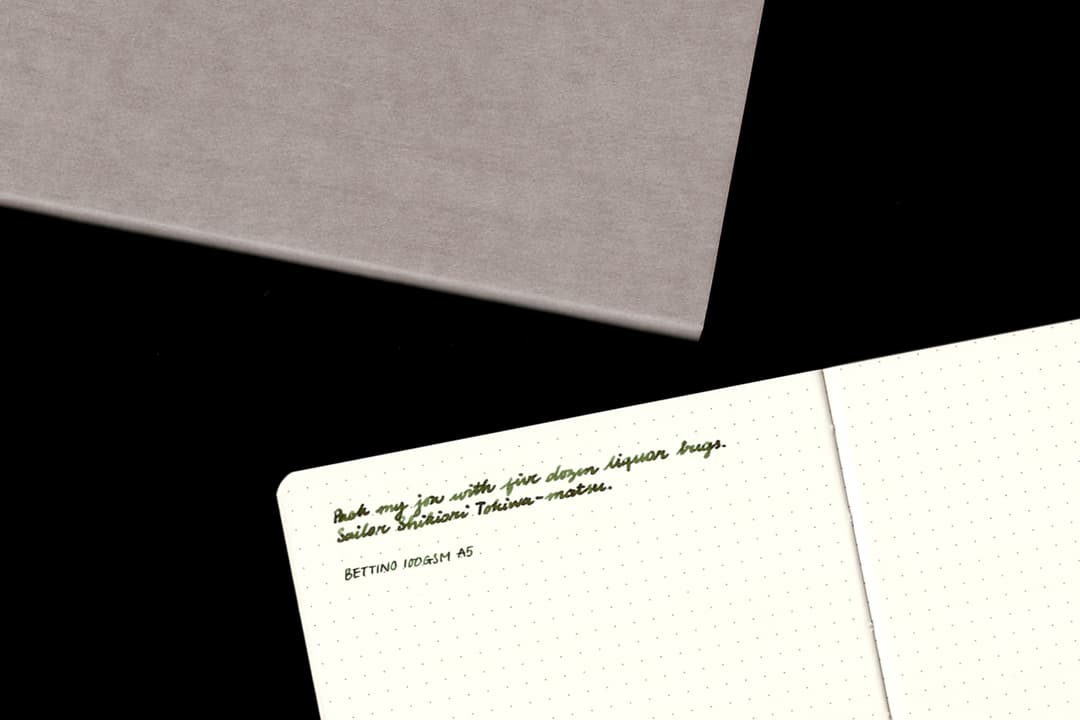 Bettino notebook cover and interior with writing sample.